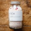 Picture of a jar of Octo's Calm bath salts laying on a wooden background.